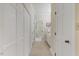 Hallway leading to a bathroom with built-in vanity and ample storage cabinets at 7709 Oakmont Pl, Raleigh, NC 27615
