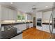 Bright kitchen featuring granite countertops, stainless steel appliances, and wood flooring at 7709 Oakmont Pl, Raleigh, NC 27615