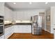 Spacious kitchen features stainless steel appliances, plenty of cabinet storage, and hardwood floors at 7709 Oakmont Pl, Raleigh, NC 27615