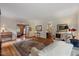 Bright living room with hardwood floors, neutral decor, and an ornate Persian-style rug at 7709 Oakmont Pl, Raleigh, NC 27615