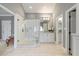Bright main bathroom featuring a glass shower, white vanity, and access to other rooms at 7709 Oakmont Pl, Raleigh, NC 27615