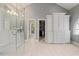 Spacious bathroom featuring a glass shower, walk-in closet, and large built-in cabinets with drawers at 7709 Oakmont Pl, Raleigh, NC 27615