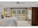 Main bedroom with natural light from large windows, carpeted floor, and wood trim at 7709 Oakmont Pl, Raleigh, NC 27615