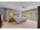 Serene main bedroom suite with large windows, ceiling fan, and neutral decor at 7709 Oakmont Pl, Raleigh, NC 27615