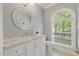 Traditional half bathroom featuring white vanity with marble countertop and large window at 7709 Oakmont Pl, Raleigh, NC 27615