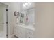 Cozy powder room featuring a white vanity with marble top and stylish mirror at 7709 Oakmont Pl, Raleigh, NC 27615