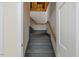 Image of a gray painted stairwell with wooden handrail leading to storage space at 7709 Oakmont Pl, Raleigh, NC 27615