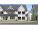 Charming new construction townhome featuring a stylish color palette and professionally landscaped yard at 801 Fireship Rd, Fuquay Varina, NC 27526