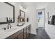 Bright bathroom featuring a double vanity with modern faucets and gray tile flooring at 801 Hyperion Aly, Wake Forest, NC 27587