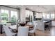 Inviting dining area adjacent to a modern kitchen, featuring large windows and stylish decor with neighborhood views at 801 Hyperion Aly, Wake Forest, NC 27587
