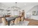 Dining room with hardwood floors, modern chandelier, large windows and staircase at 801 Hyperion Aly, Wake Forest, NC 27587