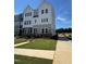 Charming new construction townhome showcasing a landscaped yard and a blend of white and gray exterior at 801 Hyperion Aly, Wake Forest, NC 27587