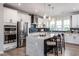 Modern kitchen featuring stainless steel appliances, a spacious island with seating, and sleek white cabinetry at 801 Hyperion Aly, Wake Forest, NC 27587