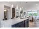 Open concept kitchen with a large island, stainless appliances, and seamlessly connected dining and living spaces at 801 Hyperion Aly, Wake Forest, NC 27587