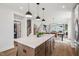 Open concept kitchen with a large kitchen island, stainless appliances, and hardwood floors at 801 Hyperion Aly, Wake Forest, NC 27587