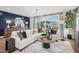 Living room with a large sectional sofa, hardwood floors, stylish decor and large window at 801 Hyperion Aly, Wake Forest, NC 27587