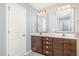 Bathroom boasts a double vanity with dark wood cabinetry and tile flooring at 8021 Crookneck Dr, Angier, NC 27501