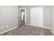 Neutral bedroom offering a view of an open doorway and a large closet at 8021 Crookneck Dr, Angier, NC 27501