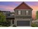 Charming two-story home with red and brown siding, stone accents, and attached two-car garage at 8021 Crookneck Dr, Angier, NC 27501