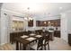 Dining area and kitchen with stainless appliances, granite counters, and island with pendant lighting at 8021 Crookneck Dr, Angier, NC 27501