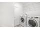 Well-equipped laundry room with modern washer, dryer, and plenty of shelving space at 8021 Crookneck Dr, Angier, NC 27501