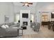 Bright living room with fireplace, large sectional sofa, accent chairs, and hardwood floors at 8021 Crookneck Dr, Angier, NC 27501