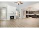 Open-concept living space featuring fireplace, access to kitchen and dining, and plenty of natural light at 8021 Crookneck Dr, Angier, NC 27501