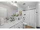 Bright bathroom featuring a white vanity, large mirror, quartz countertop, and shower-tub combo at 811 Fireship Rd, Fuquay Varina, NC 27526