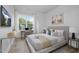 Bright bedroom with large window, modern furniture, and stylish decor at 811 Fireship Rd, Fuquay Varina, NC 27526