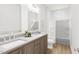Modern bathroom featuring a double sink vanity with sleek countertops and a separate shower and toilet area at 813 Fireship Rd, Fuquay Varina, NC 27526