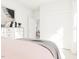 Bedroom featuring crisp white walls, mirrored dresser, and a peek into another room creating depth at 813 Fireship Rd, Fuquay Varina, NC 27526