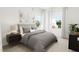Bedroom with neutral tones, large windows overlooking a garden, and stylish furniture, perfect for relaxation at 813 Fireship Rd, Fuquay Varina, NC 27526