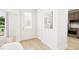 Bright entryway with natural light, wood flooring, and access to kitchen at 813 Fireship Rd, Fuquay Varina, NC 27526