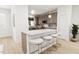 Modern kitchen with a large island, stylish seating, and stainless steel appliances at 813 Fireship Rd, Fuquay Varina, NC 27526