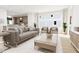 Open-concept living room with kitchen view, lots of natural light, and contemporary decor at 813 Fireship Rd, Fuquay Varina, NC 27526