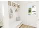 Bright mudroom with a bench, coat hooks, and storage shelves, providing a practical entry space at 813 Fireship Rd, Fuquay Varina, NC 27526
