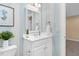 Bathroom with framed mirror, white vanity, blue striped walls, and decor at 88 Eltham, Rocky Mount, NC 27804