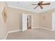 Spacious bedroom featuring a ceiling fan, neutral color palette, and doorway leading to stairs at 88 Eltham, Rocky Mount, NC 27804