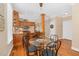 Inviting dining area with kitchen bar, a round glass table, and hardwood floors at 88 Eltham, Rocky Mount, NC 27804