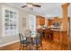 Bright dining area with a glass table, ceiling fan, and kitchen bar seating at 88 Eltham, Rocky Mount, NC 27804