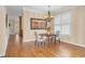 Elegant dining space with hardwood floors, a chandelier, and ample natural light streaming through the window at 88 Eltham, Rocky Mount, NC 27804