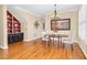 Charming dining area featuring a chandelier, hardwood floors, and a view of the built-in cabinet at 88 Eltham, Rocky Mount, NC 27804