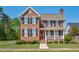 Charming two-story brick home with a red front door and a welcoming front porch and manicured front lawn at 88 Eltham, Rocky Mount, NC 27804