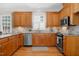Charming kitchen features wooden cabinets, stainless steel appliances, and tile backsplash at 88 Eltham, Rocky Mount, NC 27804