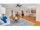 Open-concept living area with hardwood floors, a ceiling fan, and access to a bathroom and dining area at 88 Eltham, Rocky Mount, NC 27804