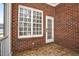 Enclosed brick porch with a window, brick wall and white door at 88 Eltham, Rocky Mount, NC 27804