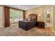 Comfortable bedroom with plush carpeting, a large window, and stylish furnishings at 919 Woodham, Pittsboro, NC 27312