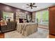 Bedroom with large windows and a decorative ceiling fan at 919 Woodham, Pittsboro, NC 27312