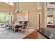 Elegant dining room featuring modern chandeliers and ample seating at 919 Woodham, Pittsboro, NC 27312