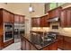 Kitchen with stainless appliances, island with bar sink and granite countertops with tile backsplash at 919 Woodham, Pittsboro, NC 27312